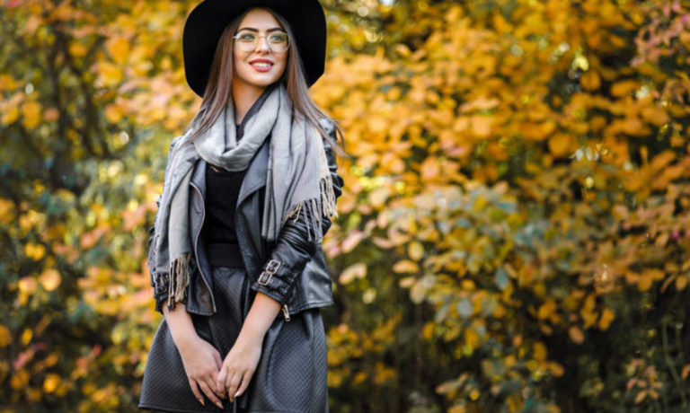 Frau im herbstlichen Look mit schwarzem Hut